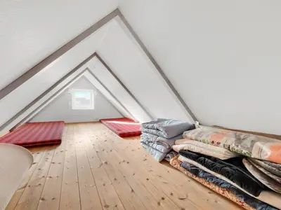 a pile of blankets on the floor of a attic at Holiday Home Ebba - 25m from the sea by Interhome in Frøstrup