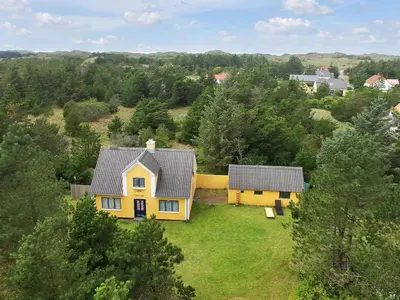 an aerial view of a yellow house in a field at Holiday Home Margrethe - 1-1km from the sea by Interhome in Bedsted Thy
