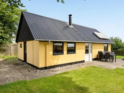 a yellow house with a black roof at Holiday Home Leocadia - 150m to the fjord by Interhome in Øsløs