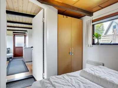 a bedroom with a bed and a large window at Holiday Home Leocadia - 150m to the fjord by Interhome in Øsløs