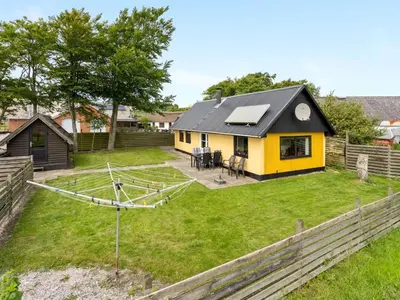 a yellow and black house with a yard at Holiday Home Leocadia - 150m to the fjord by Interhome in Øsløs
