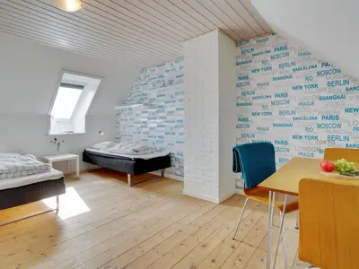 a room with a bed and a table and chairs at Holiday Home Markhild - 300m to the fjord by Interhome in Sønder Ydby