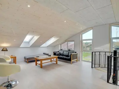 a living room with a couch and a table at Holiday Home Markhild - 300m to the fjord by Interhome in Sønder Ydby