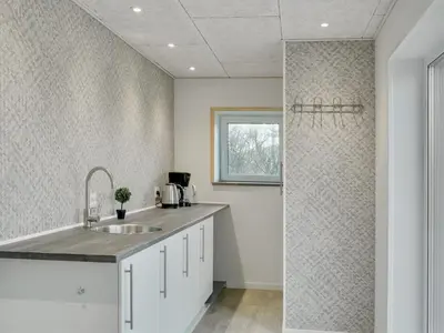 a kitchen with a sink and a shower at Holiday Home Markhild - 300m to the fjord by Interhome in Sønder Ydby