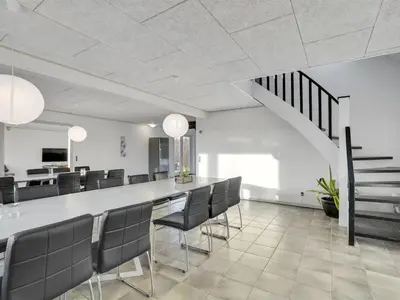 a dining room with a long table and chairs at Holiday Home Markhild - 300m to the fjord by Interhome in Sønder Ydby