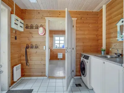 a laundry room with a washer and dryer at Holiday Home Bjarnger - 200m from the sea by Interhome in Frøstrup