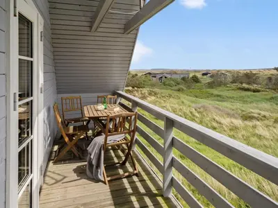 a patio with a table and chairs on a porch at Holiday Home Bjarnger - 200m from the sea by Interhome in Frøstrup