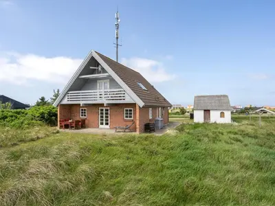 a small house in a field of grass at Holiday Home Bjarnger - 200m from the sea by Interhome in Frøstrup