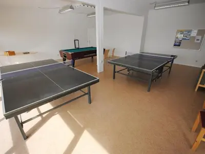 two ping pong tables in a room with a pool table at Apartment Hubertine - 100m to the fjord by Interhome in Vestervig