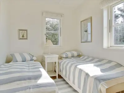 two beds in a white room with two windows at Apartment Hubertine - 100m to the fjord by Interhome in Vestervig