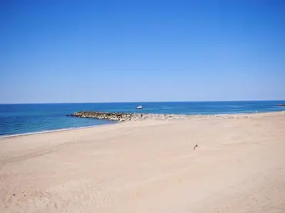 a sandy beach with the ocean in the background at Apartment Stelle - 100m to the fjord by Interhome in Vestervig