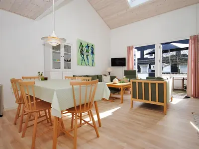 a dining room and living room with a table and chairs at Apartment Benta - 150m to the fjord by Interhome in Vestervig