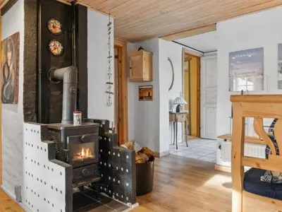a wood stove in a room with a hallway at Holiday Home Gertina - 40m to the fjord by Interhome in Vestervig