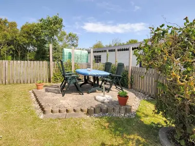 a patio with a table and chairs in a yard at Holiday Home Gertina - 40m to the fjord by Interhome in Vestervig