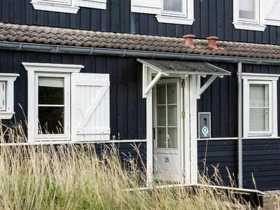 a black house with white windows and a door at Apartment Tofan - 100m to the fjord by Interhome in Vestervig