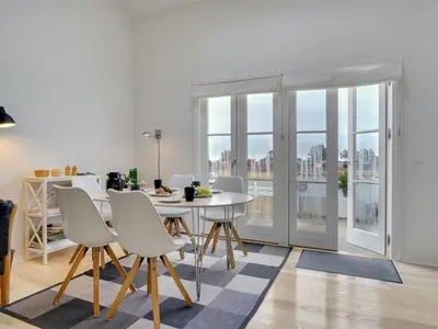 a dining room with a white table and chairs at Apartment Tofan - 100m to the fjord by Interhome in Vestervig