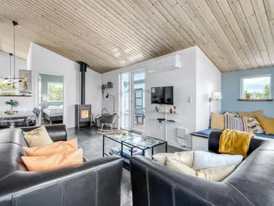 a living room with two leather couches and a tv at Holiday Home Selke - 300m to the fjord by Interhome in Vestervig