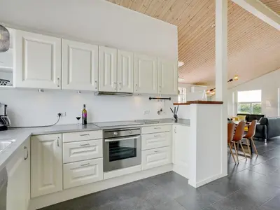 a white kitchen with white cabinets and a counter at Holiday Home Selke - 300m to the fjord by Interhome in Vestervig
