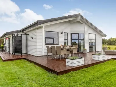 a house with a deck with a table and chairs at Holiday Home Selke - 300m to the fjord by Interhome in Vestervig