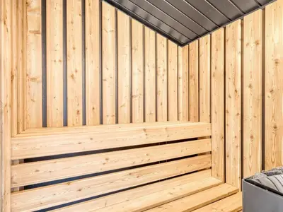 a wooden sauna with a wood paneled wall at Holiday Home Selke - 300m to the fjord by Interhome in Vestervig