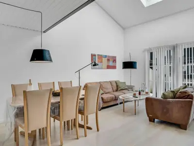 a living room with a table and a couch at Apartment Eleen - 100m to the fjord by Interhome in Vestervig