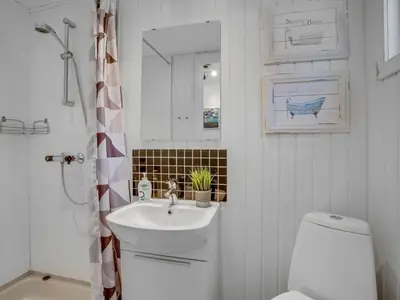 a white bathroom with a sink and a toilet at Apartment Eleen - 100m to the fjord by Interhome in Vestervig