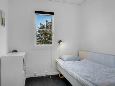 a bedroom with a bed and a window at Apartment Eleen - 100m to the fjord by Interhome in Vestervig