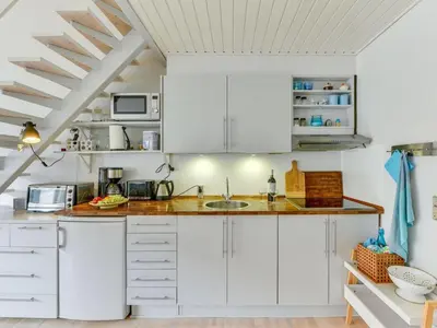 a kitchen with white cabinets and a sink at Apartment Cita - 100m to the fjord by Interhome in Vestervig