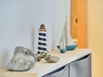 a shelf with a lighthouse and other items on it at Apartment Cita - 100m to the fjord by Interhome in Vestervig