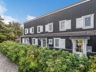 an exterior view of a black building with white windows at Apartment Cita - 100m to the fjord by Interhome in Vestervig