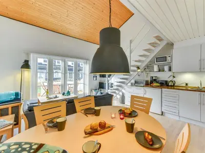 a kitchen and dining room with a table and chairs at Apartment Cita - 100m to the fjord by Interhome in Vestervig