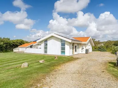 a white house with an orange roof at Holiday Home Sulevi - 200m to the fjord by Interhome in Vestervig