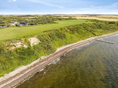an aerial view of a golf course and the ocean at Holiday Home Sulevi - 200m to the fjord by Interhome in Vestervig