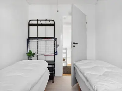 two beds in a room with white walls at Apartment Hermanda - 100m to the fjord by Interhome in Vestervig