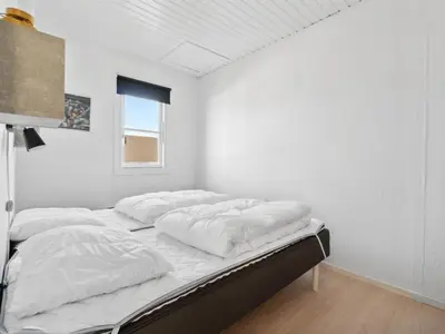 a white room with a bed with white sheets at Apartment Hermanda - 100m to the fjord by Interhome in Vestervig