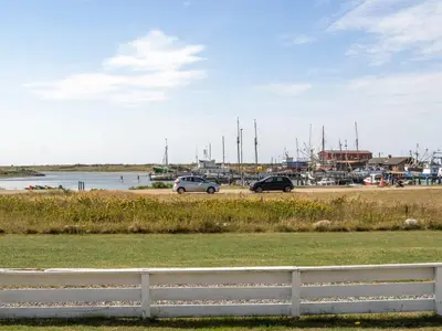 two cars parked in a parking lot near a marina at Apartment Idunn - 100m to the fjord by Interhome in Vestervig