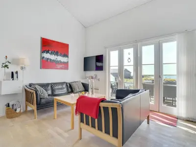 a living room with a couch and a table at Apartment Idunn - 100m to the fjord by Interhome in Vestervig
