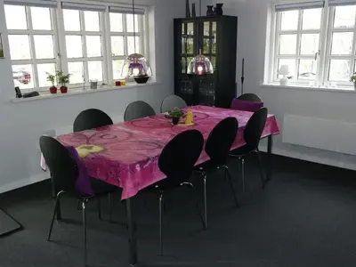 a dining room with a pink table and chairs at Holiday Home Assarina - 300m to the fjord by Interhome in Vinderup