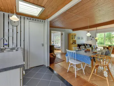 a kitchen and dining room with a table and chairs at Holiday Home Sebastian - 100m to the fjord by Interhome in Thyholm