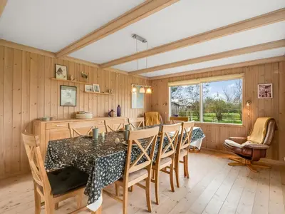 a dining room with a table and chairs at Holiday Home Scarlet - 400m to the fjord by Interhome in Vinderup