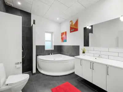 a bathroom with a tub and a toilet and a sink at Holiday Home Jarven - 500m to the fjord by Interhome in Højslev
