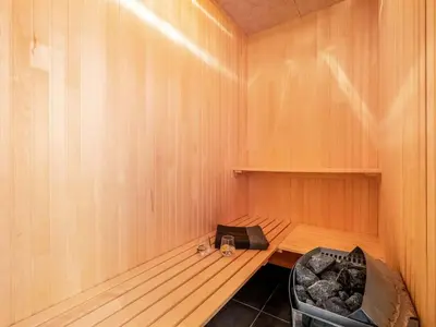 a sauna with a chair in a wooden room at Holiday Home Jarven - 500m to the fjord by Interhome in Højslev