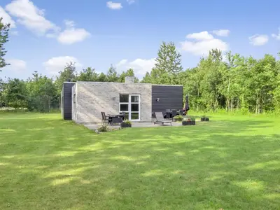 a small cabin in a field with a yard at Holiday Home Jarven - 500m to the fjord by Interhome in Højslev