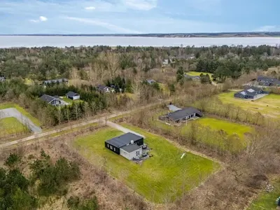 an aerial view of a house with a yard and a lake at Holiday Home Jarven - 500m to the fjord by Interhome in Højslev
