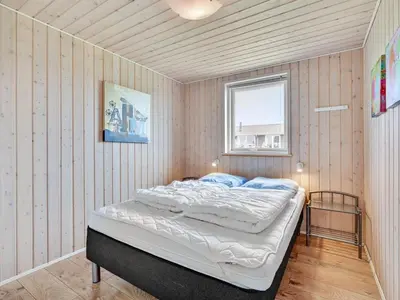 a bedroom with a bed in a room with a window at Holiday Home Nahel - 150m to the fjord by Interhome in Vinderup
