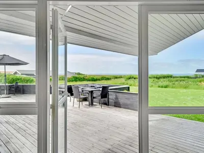 a view of a patio with a table and chairs at Holiday Home Nahel - 150m to the fjord by Interhome in Vinderup