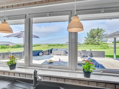 a kitchen window with a view of a patio at Holiday Home Nahel - 150m to the fjord by Interhome in Vinderup