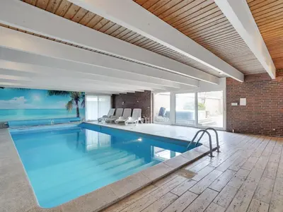 a swimming pool in a house with a brick wall at Holiday Home Rahild - 2km to the fjord by Interhome in Thyholm