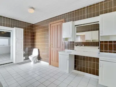 a bathroom with a toilet and a sink and a mirror at Holiday Home Rahild - 2km to the fjord by Interhome in Thyholm