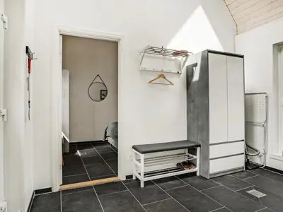 a room with white walls and a door with a bench at Holiday Home Angelita - 80m to the fjord by Interhome in Thyholm